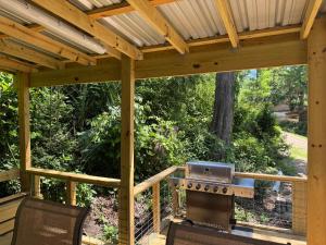 a wooden pergola with a grill on a patio at Canvasback Cove on Caddo Lake in Jefferson