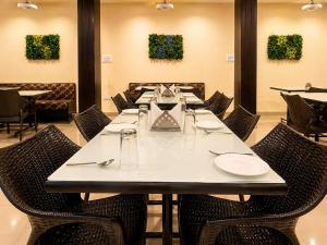 a dining room with a long table and chairs at Hotel Ace Plaza in Udaipur