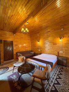 a bedroom with a large bed in a wooden room at Ela Sultan Han Otel in Gaziantep