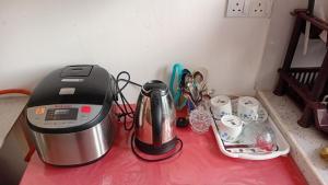 a counter top with a coffee maker and a blender at Ariyana Sky Suites in Matara