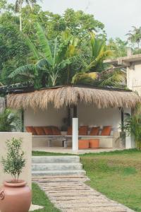 a house with a straw roof and a pool at Casa Mariposa in Ahangama +35 photos