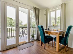 a dining room with a table and chairs and a balcony at 1 Bed in Llangammarch Wells oc-bn020 in Garth