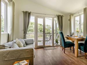 a living room with a couch and a table at 1 Bed in Llangammarch Wells oc-bn020 in Garth