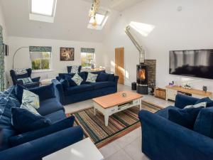 a living room with blue couches and a tv at 3 Bed in Poulton-le-fylde oc-83787 in Hambleton