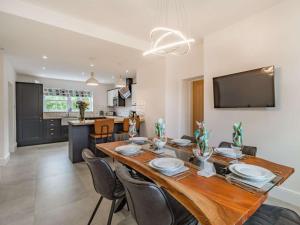 a dining room with a large wooden table and chairs at 3 Bed in Poulton-le-fylde oc-83787 in Hambleton