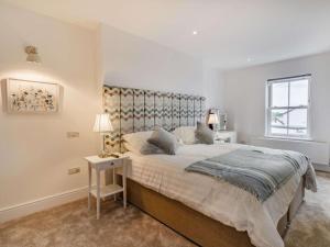 a white bedroom with a large bed and a window at 3 Bed in Poulton-le-fylde oc-83787 in Hambleton