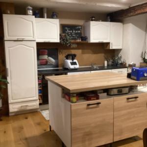 a kitchen with white cabinets and a counter top at Vincenzo le cyclo in Kientzheim