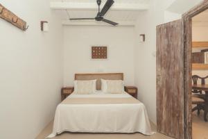 a bedroom with a bed and a ceiling fan at Casa Mariposa in Ahangama