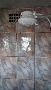 a tile floor with a toilet on top of it at Kitnet quarto e cozinha ha 3min da Unifesp in São Paulo +13 photos