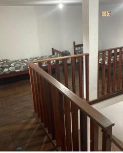 a room with two bunk beds and a staircase at Makana Surf Camp in Ubatuba