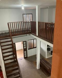 a room with a staircase and a stair case at Makana Surf Camp in Ubatuba
