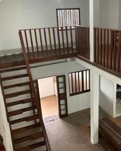 a staircase in a house with a stair case at Makana Surf Camp in Ubatuba