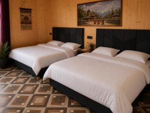 two beds in a room with white sheets at Harshil Pinewood Homestay in Harsil