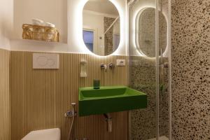 a bathroom with a green sink and a shower at Al centro di Roma in Rome +26 photos