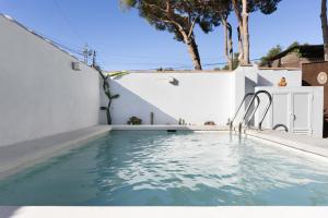 a swimming pool in a house with a white wall at Bungalow Cádiz Costa in Chiclana de la Frontera