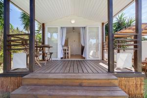 a porch of a house with a wooden deck at Bungalow Cádiz Costa in Chiclana de la Frontera