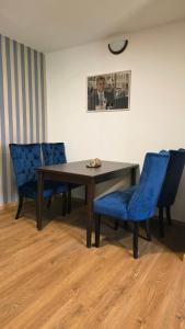 a table and two blue chairs in a room at Villa Mila in Loket +15 photos