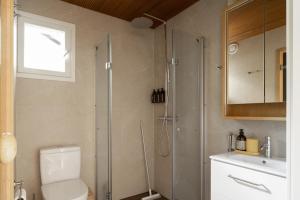 a bathroom with a shower and a toilet and a sink at Villa MiaEmilia A in Espoo +20 photos