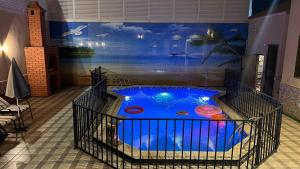 a room with a large blue tub with a painting on the wall at شاليهات بتلات الورد in Taif