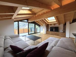 a living room with a large couch and a tv at Diana 9 in Leukerbad