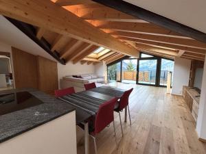 a kitchen and dining room with a table and chairs at Diana 9 in Leukerbad