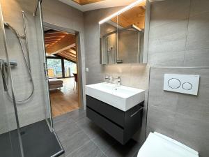 a bathroom with a sink and a shower at Diana 9 in Leukerbad +40 photos