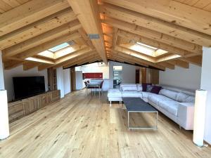 a large living room with a couch and a tv at Diana 9 in Leukerbad