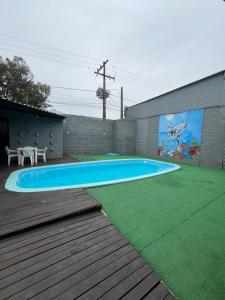 a swimming pool in a yard with a table at Studio Completo AC Piscina Pet Friendly NH in Novo Hamburgo