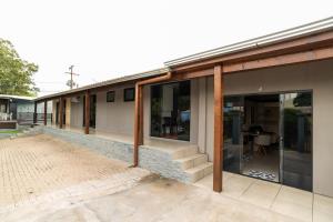 an external view of a house with sliding glass doors at Studio Completo AC Piscina Pet Friendly NH in Novo Hamburgo