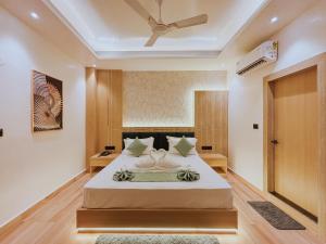 a bedroom with a bed and a ceiling fan at Regal Havens in Jorhat