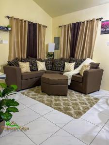 a living room with a couch and a rug at Phoenix Eden in Portmore