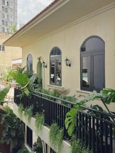 a house with a balcony with plants on it at G'Villa Thảo Điền in Ho Chi Minh City