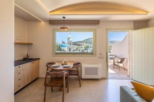 a kitchen and dining room with a table and chairs at Casita Suites in Megalochori