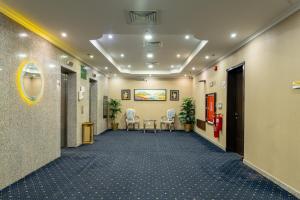 a hallway with chairs and a table in a building at واحد لواحد للشقق المخدومة -اقتصادي in Al Khobar +68 photos