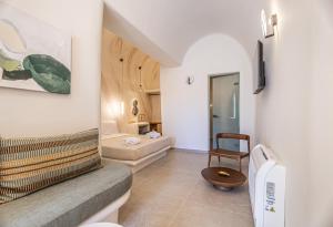 a living room with a couch and a chair at Casita Suites in Megalochori +97 photos