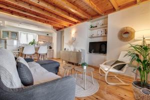 a living room with a couch and a table at Ionelia Hospitality Apartments in Ipsos