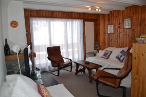 a living room with a bed and a couch and a chair at Immeuble Panorama in Les Collons +35 photos