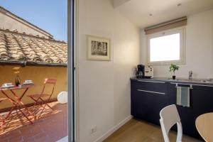 a kitchen with a counter and a table and a window at Al centro di Roma in Rome