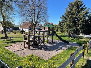 a playground with a slide in a park at Ferienhaus Weitblick in Masserberg