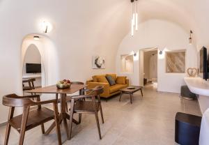 a living room with a table and a couch at Casita Suites in Megalochori