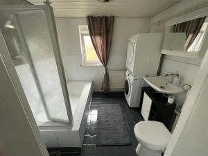 a small bathroom with a toilet and a sink at Ferienhaus Weitblick in Masserberg +21 photos