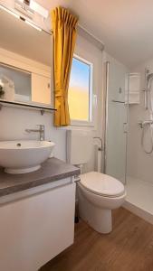 a bathroom with a sink and a toilet and a shower at Iris Holiday Homes in Biograd na Moru +116 photos