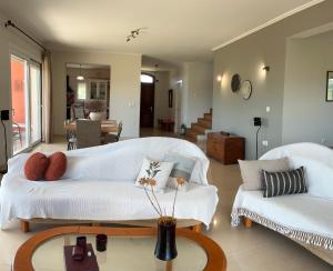 a living room with two white couches and a table at Horizon House, with Olive Grove and a small Vineyard in Amarynthos +50 photos