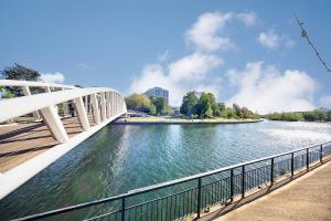 a bridge over a river next to a city at Bedford Retreat in Bedford