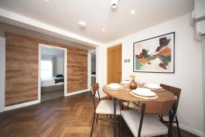 a dining room with a table and chairs and a bedroom at Bedford Retreat in Bedford