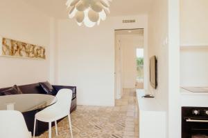 a kitchen and living room with a table and chairs at Venti D'Amare Suites in Polignano a Mare