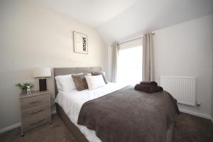 a bedroom with a large bed and a window at Bedford Retreat in Bedford