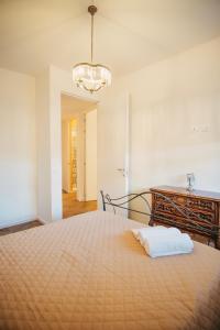 a bedroom with a bed and a chandelier at Venti D'Amare Suites in Polignano a Mare +49 photos