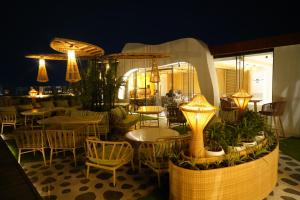 a restaurant with tables and chairs and lights at Clarion Inn Greywall By Choice Hotels in Amritsar