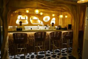 two men sitting at a bar in a restaurant at Clarion Inn Greywall By Choice Hotels in Amritsar